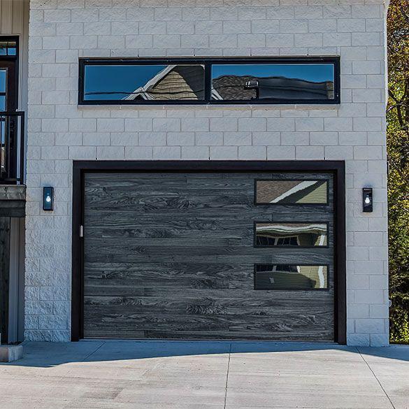 Charcoal wood-tone garage door on a modern home