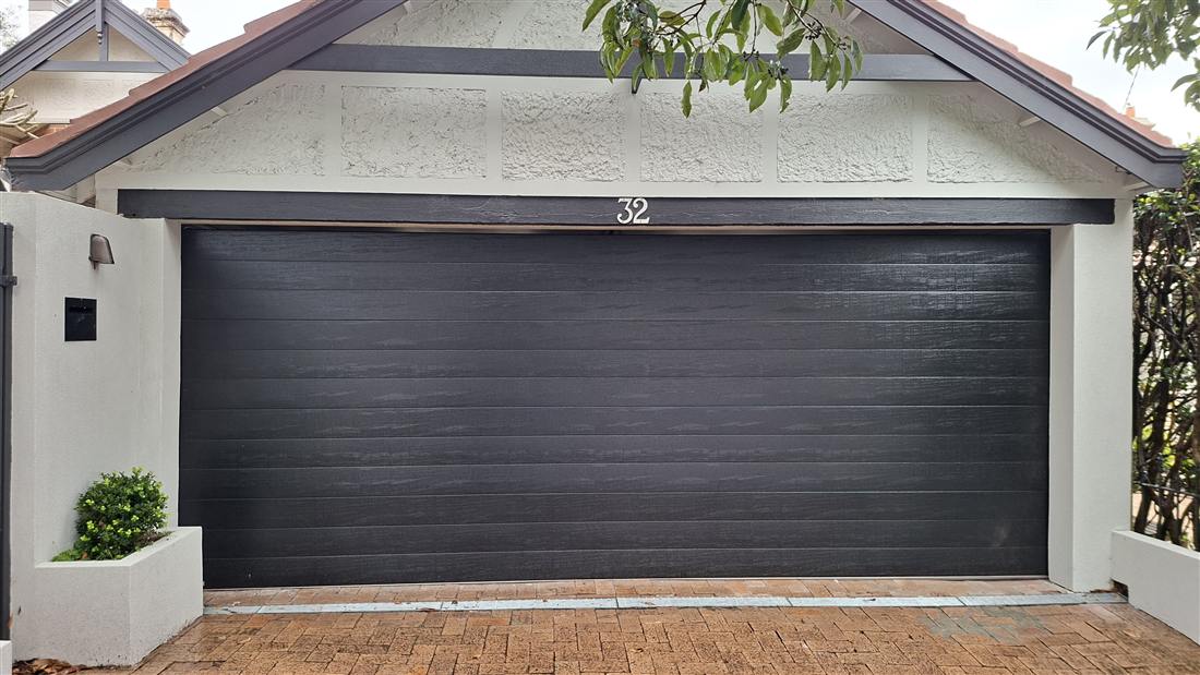 New charcoal panel garage door installed by AM/PM Garage Door