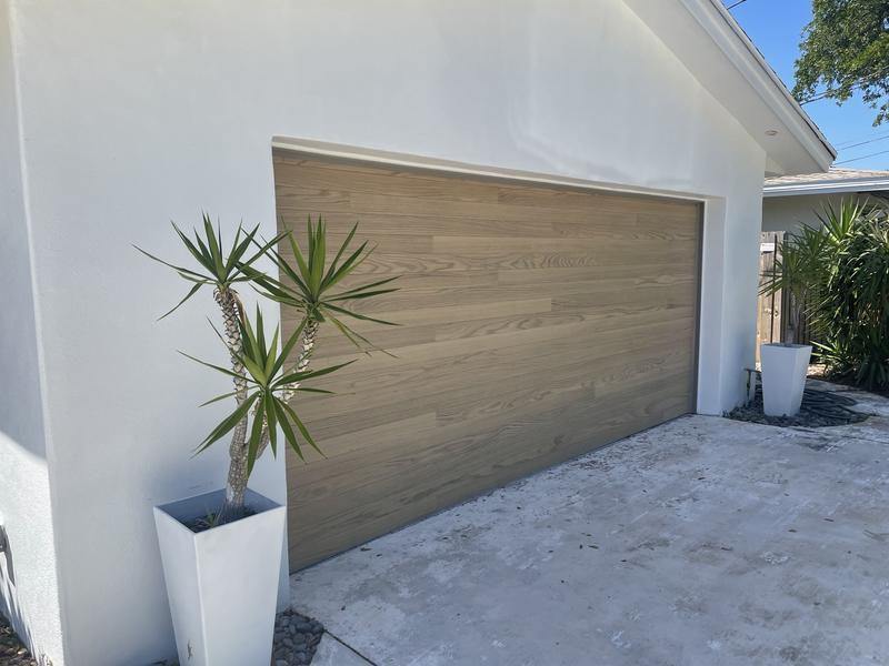 Modern wood-look garage door installed by AM/PM Garage Door